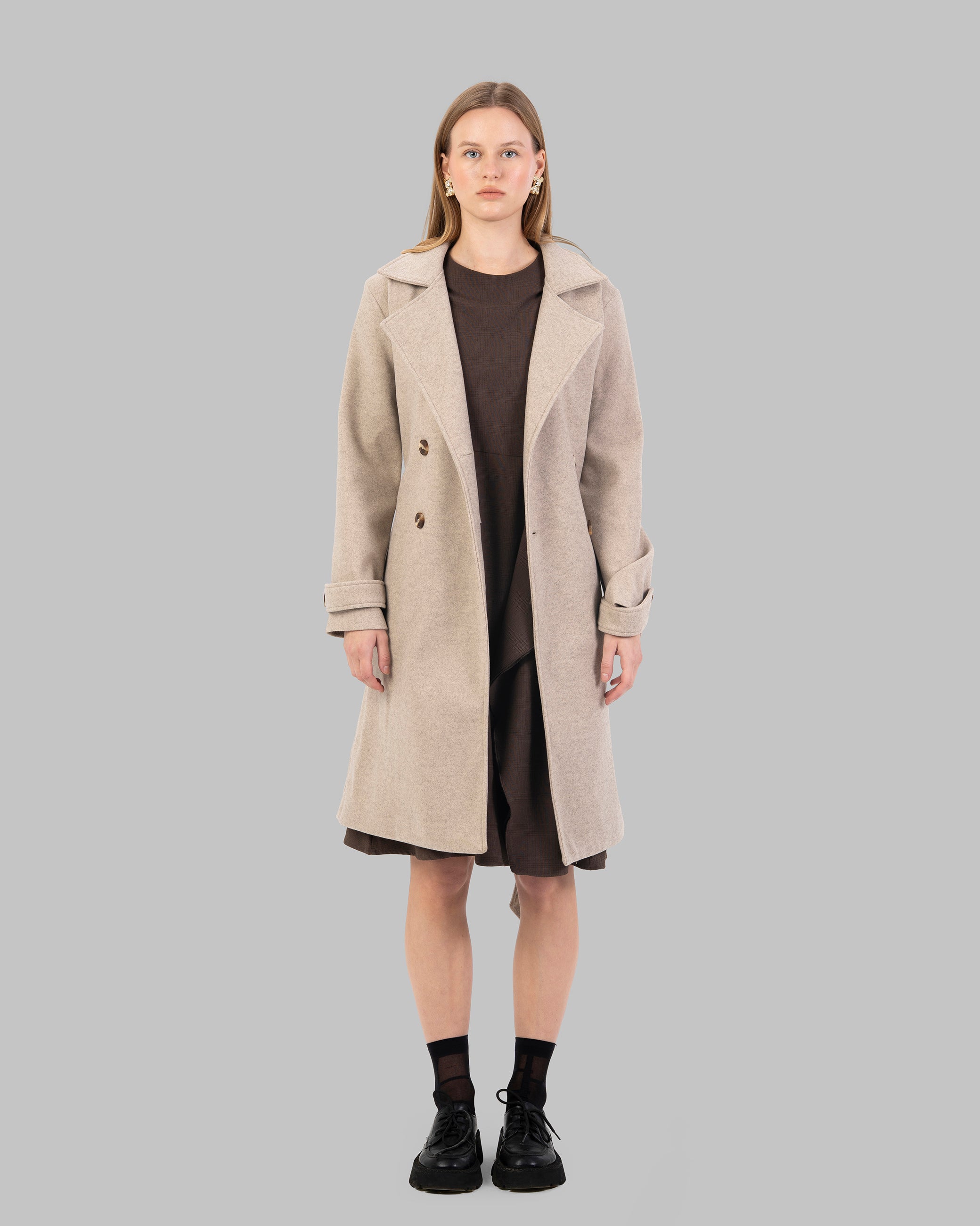 A classic light beige belted coat with a wide collar