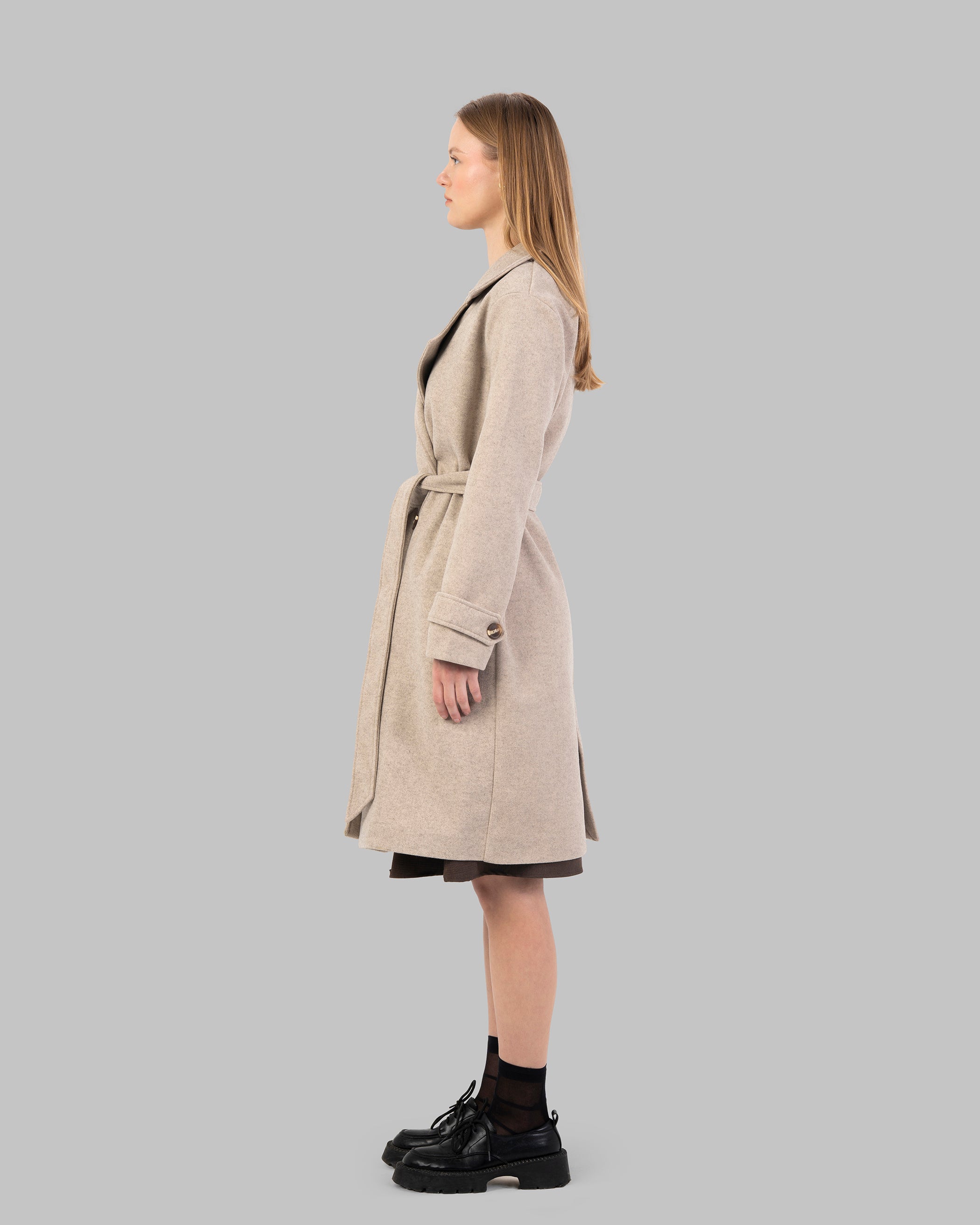 A classic light beige belted coat with a wide collar