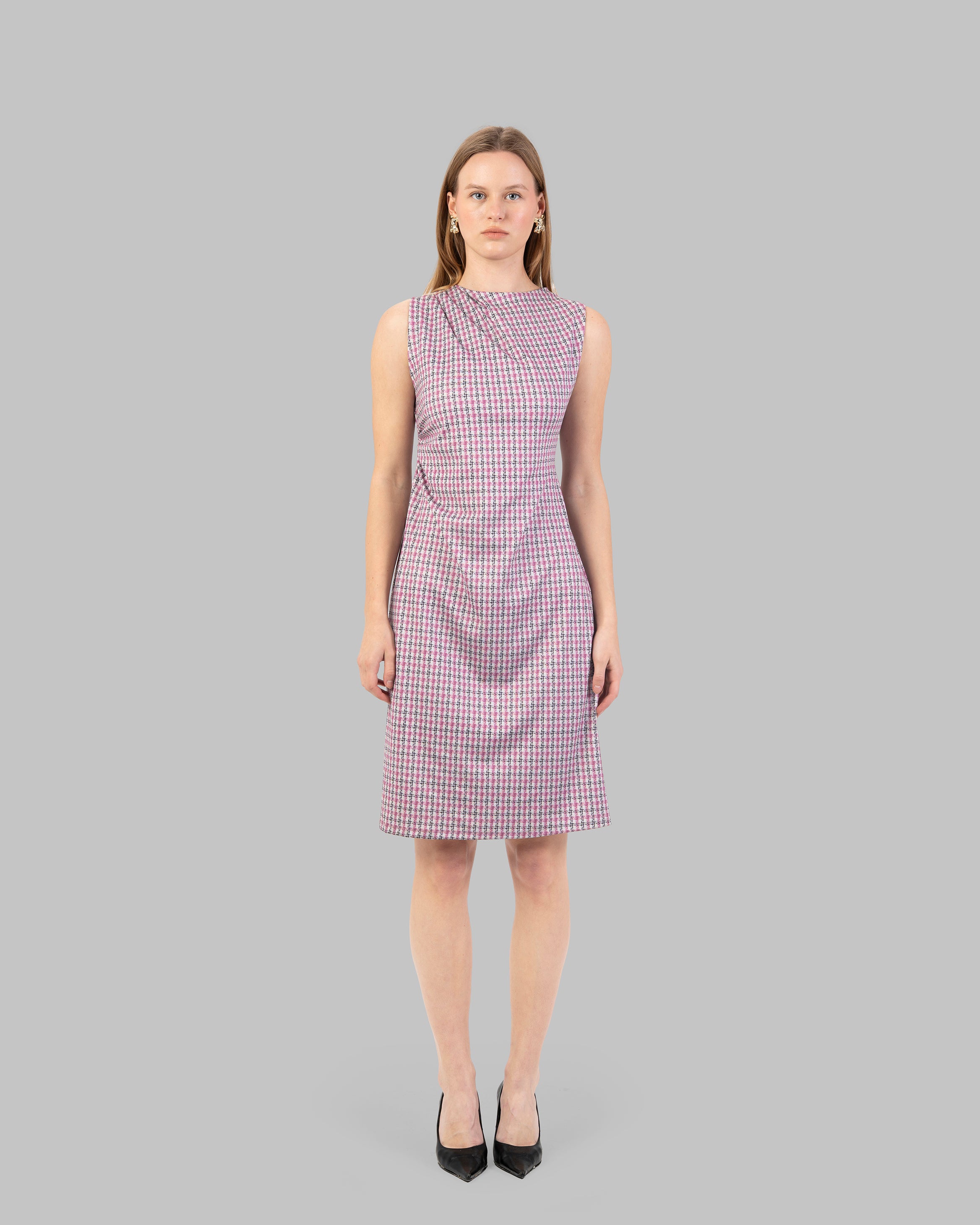 fitted dress with a pink and black houndstooth pattern.