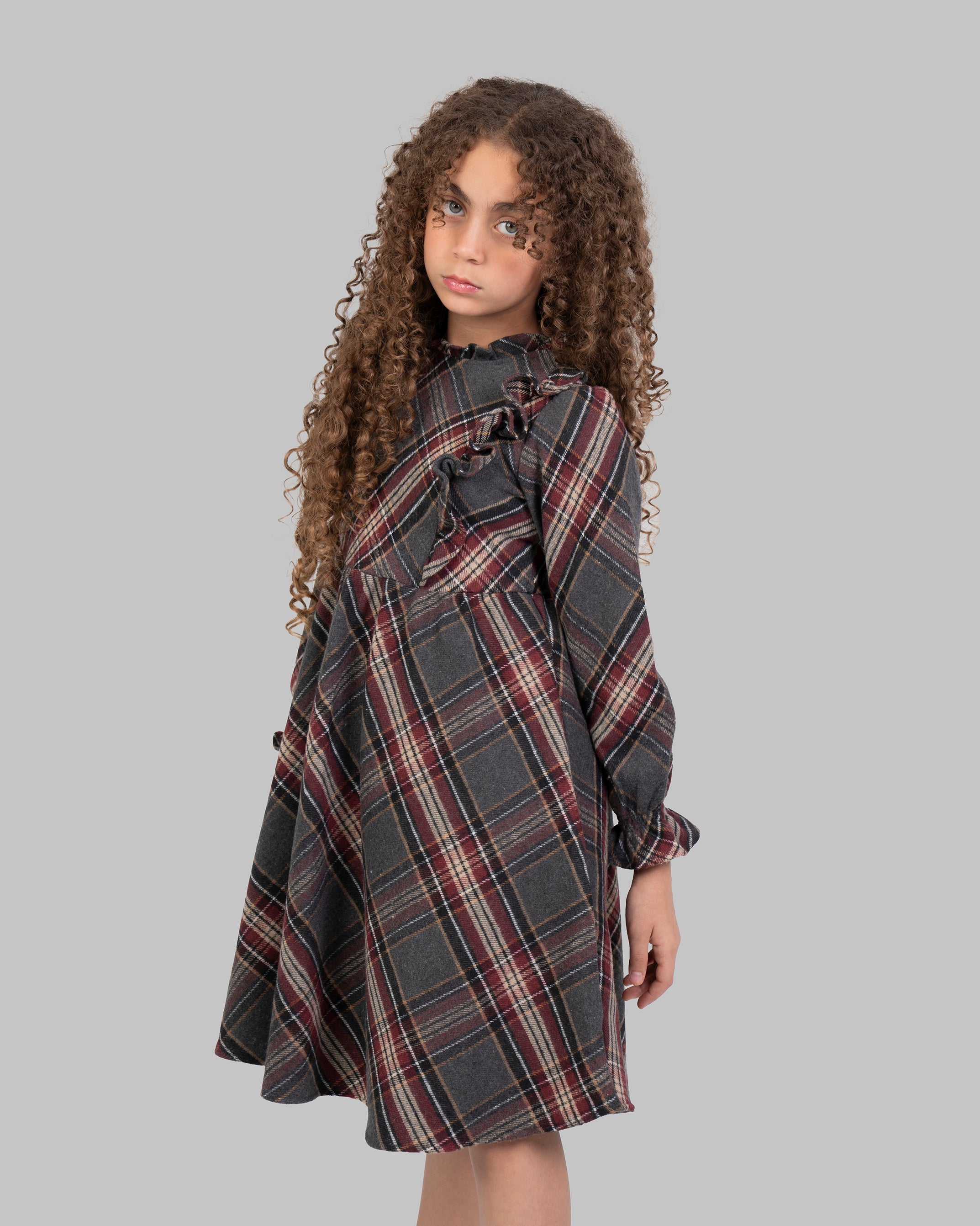 Knee-length plaid dress, with long sleeves.