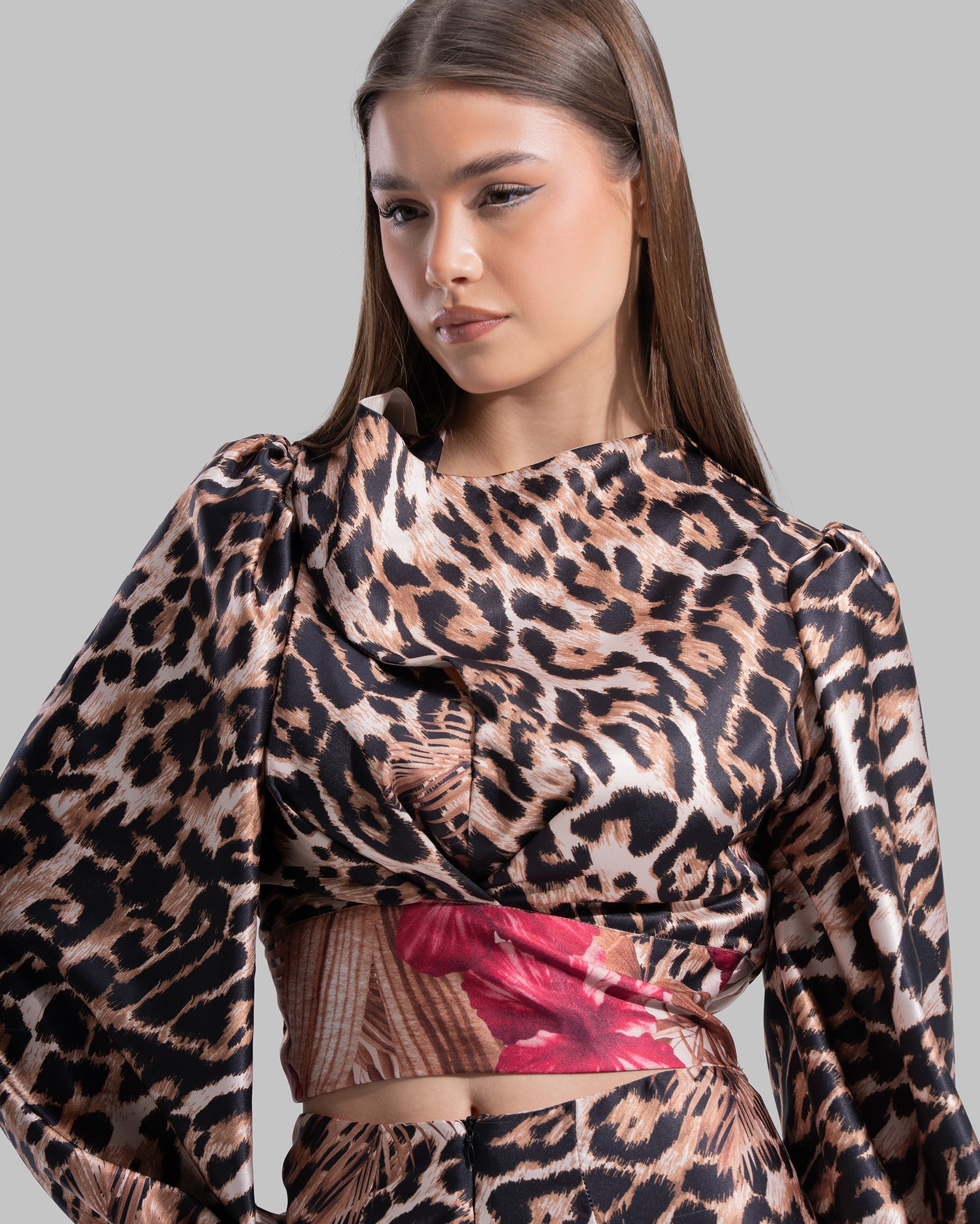 Long sleeve top with a draped neckline and slightly puffed shoulders.