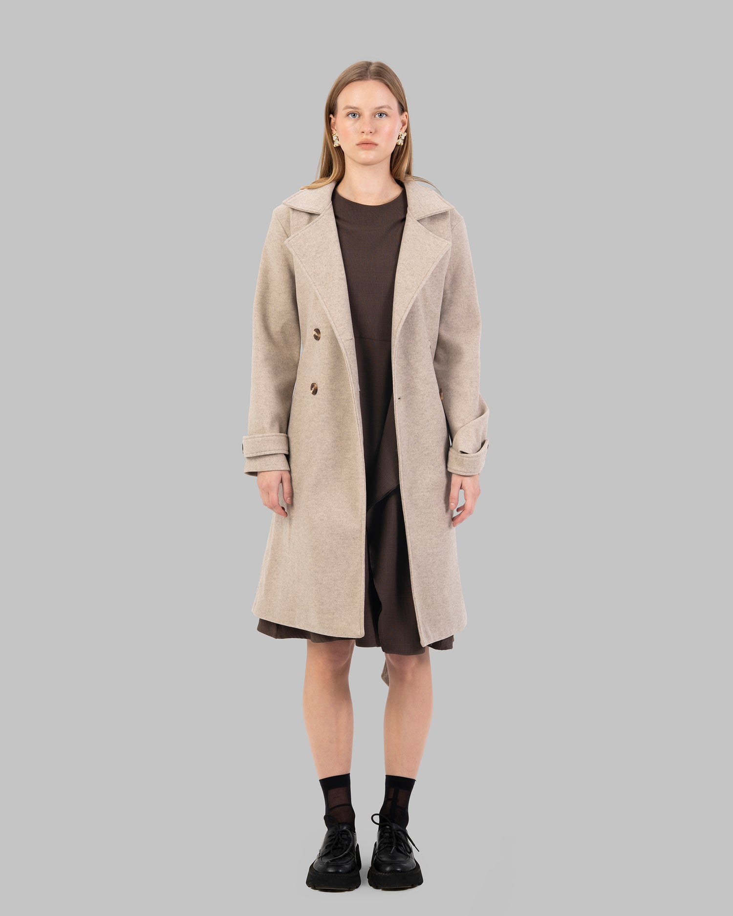 A classic light beige belted coat with a wide collar