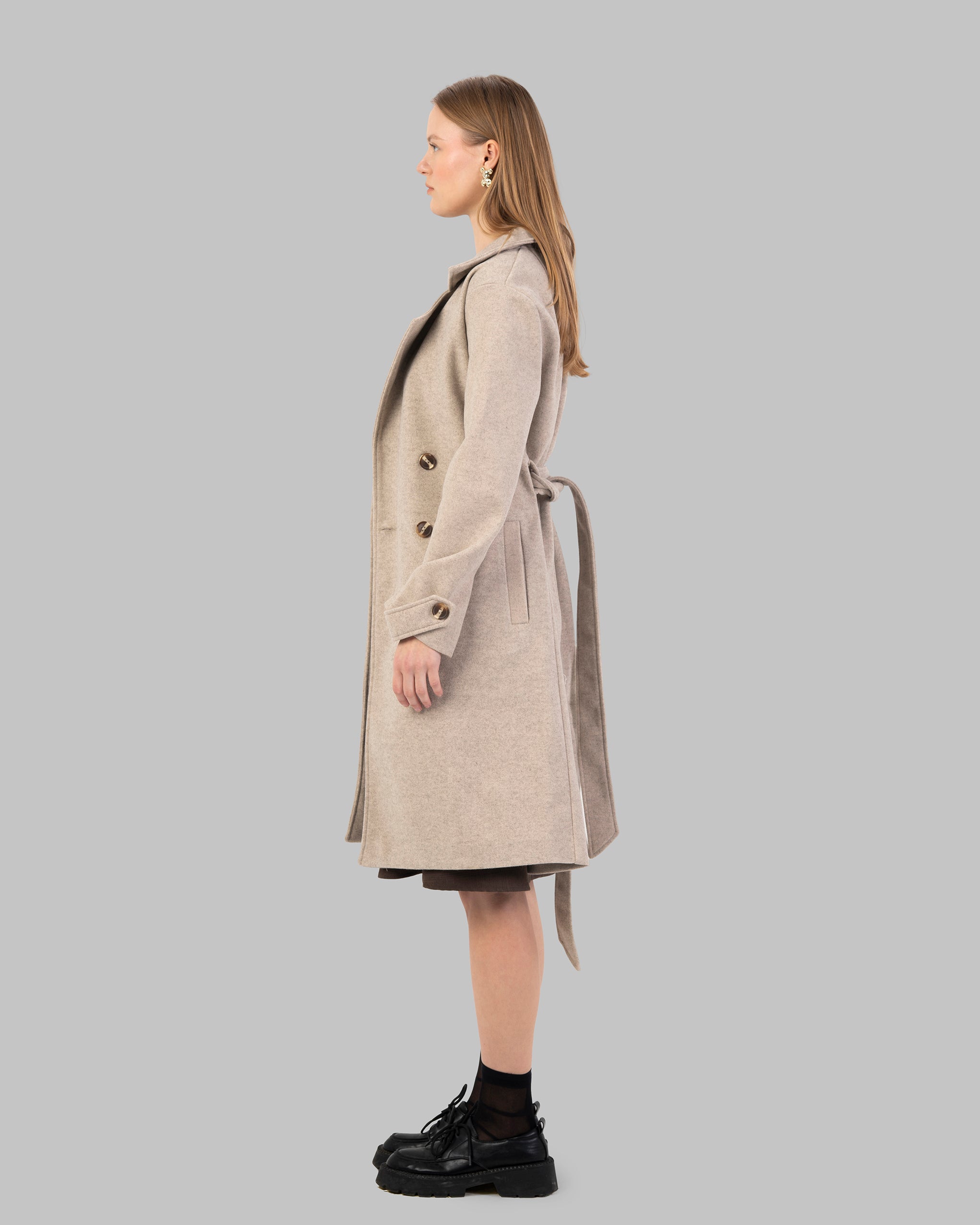 A classic light beige belted coat with a wide collar