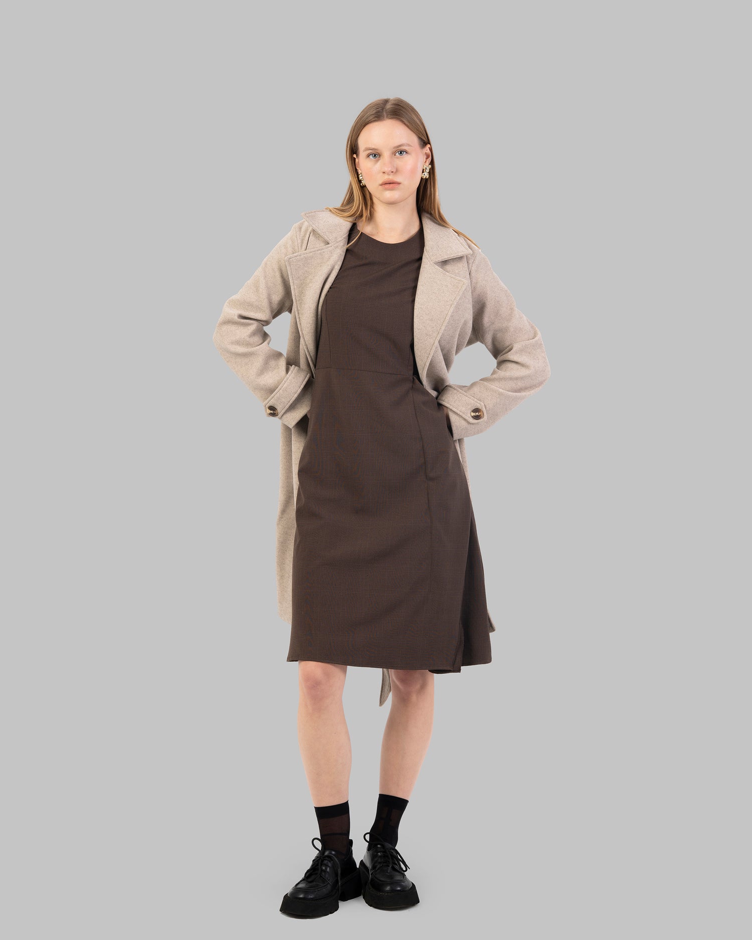 A classic light beige belted coat with a wide collar