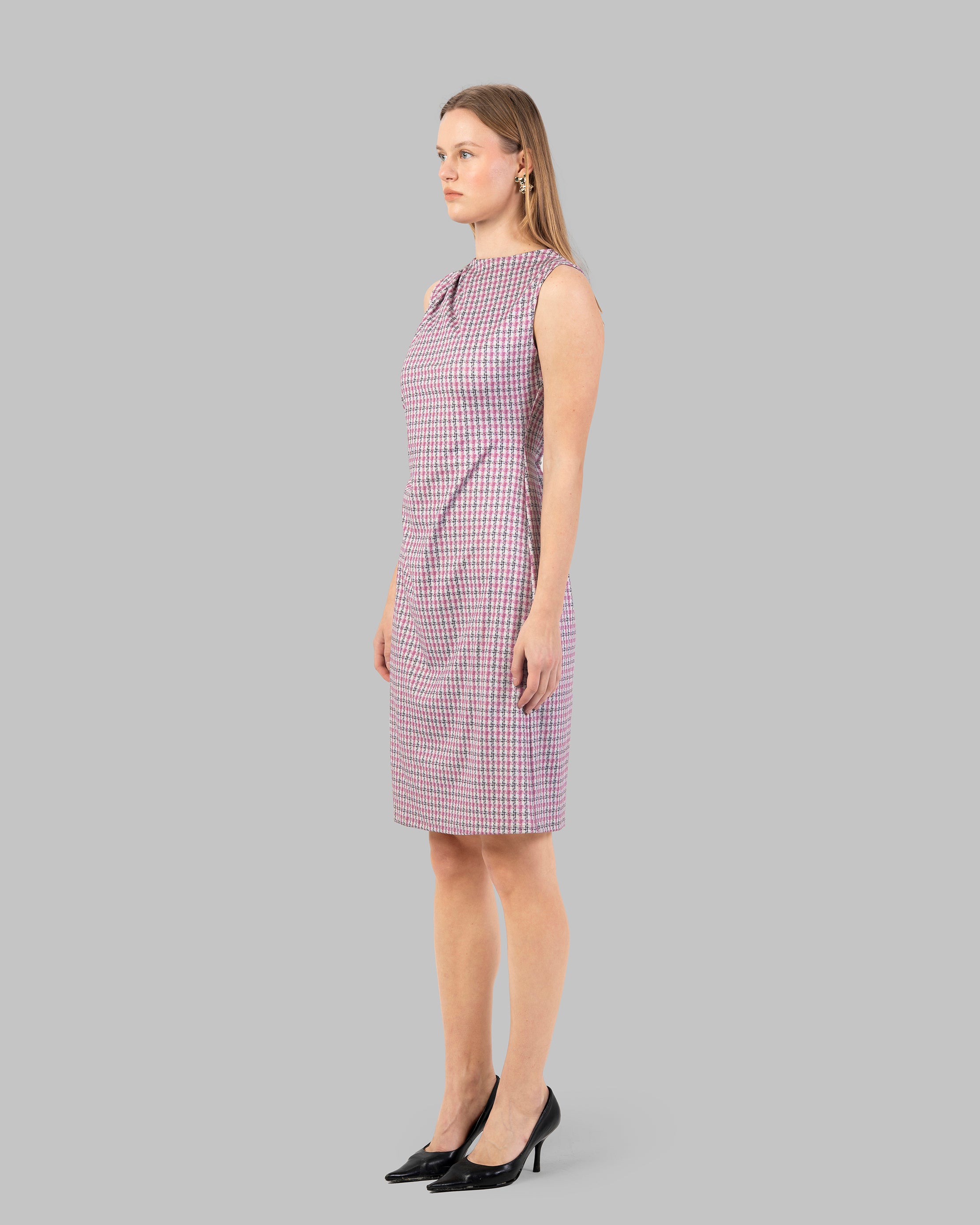 fitted dress with a pink and black houndstooth pattern.