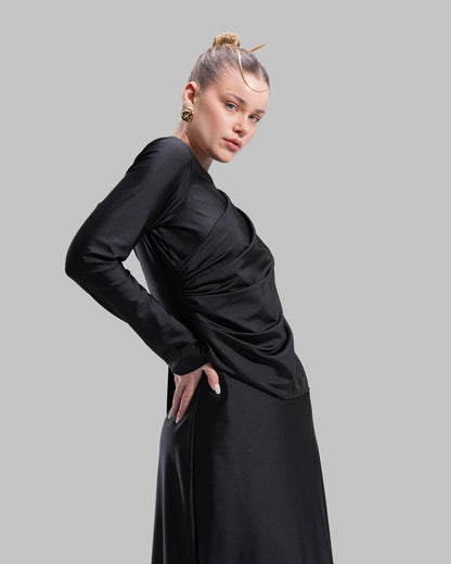 Long draped dress with a round neckline and asymmetrical overlay detail.