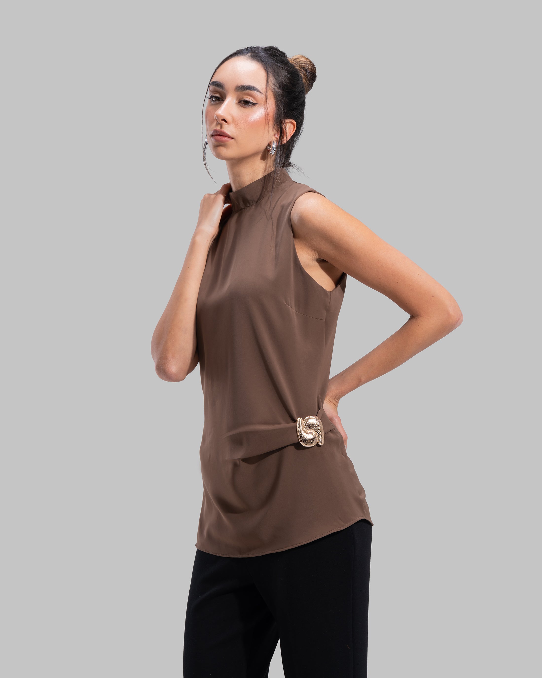 Sleeveless high-neck top with gathered detail and a metallic side buckle.