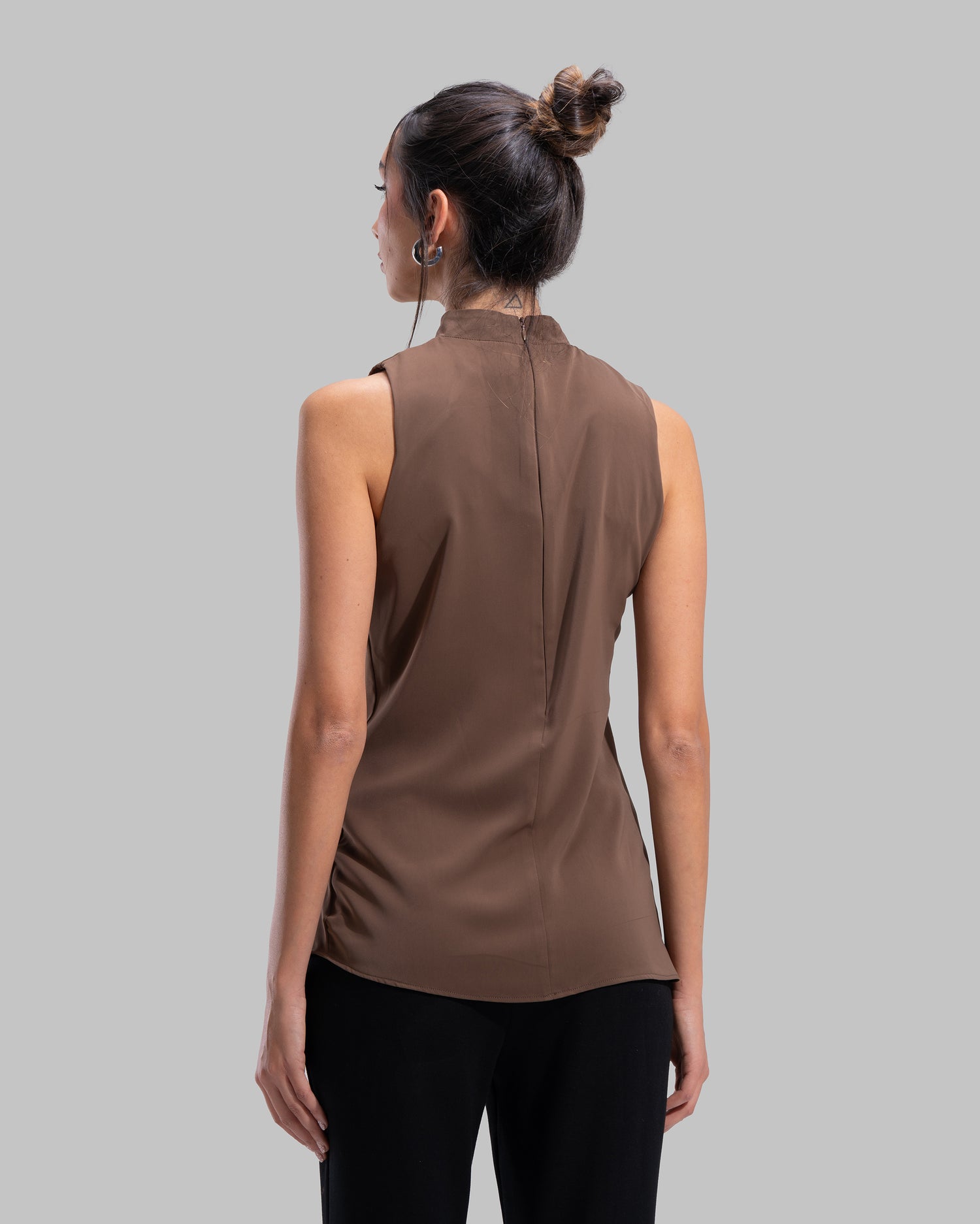 Sleeveless high-neck top with gathered detail and a metallic side buckle.