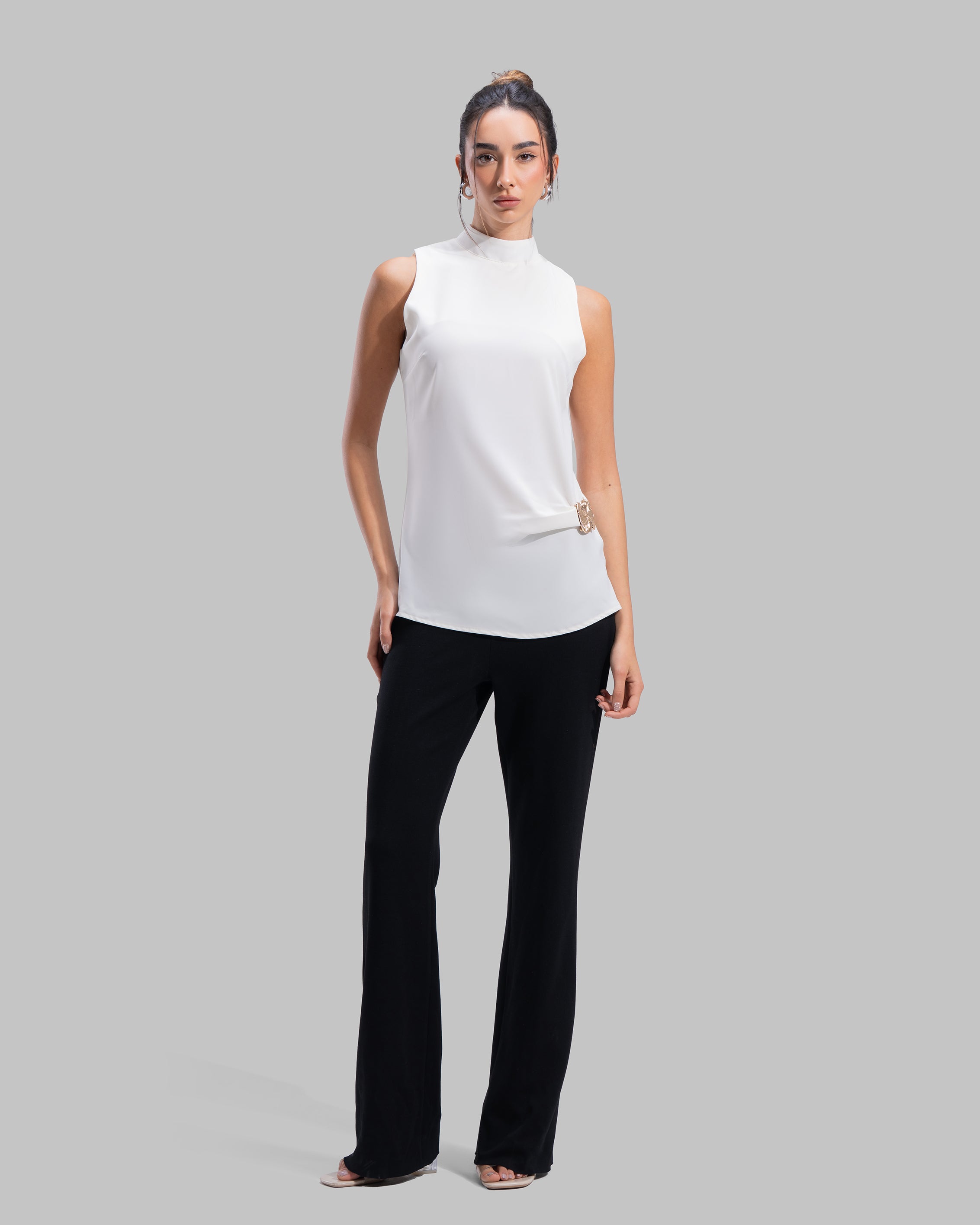 Sleeveless high-neck top with gathered detail and a metallic side buckle.