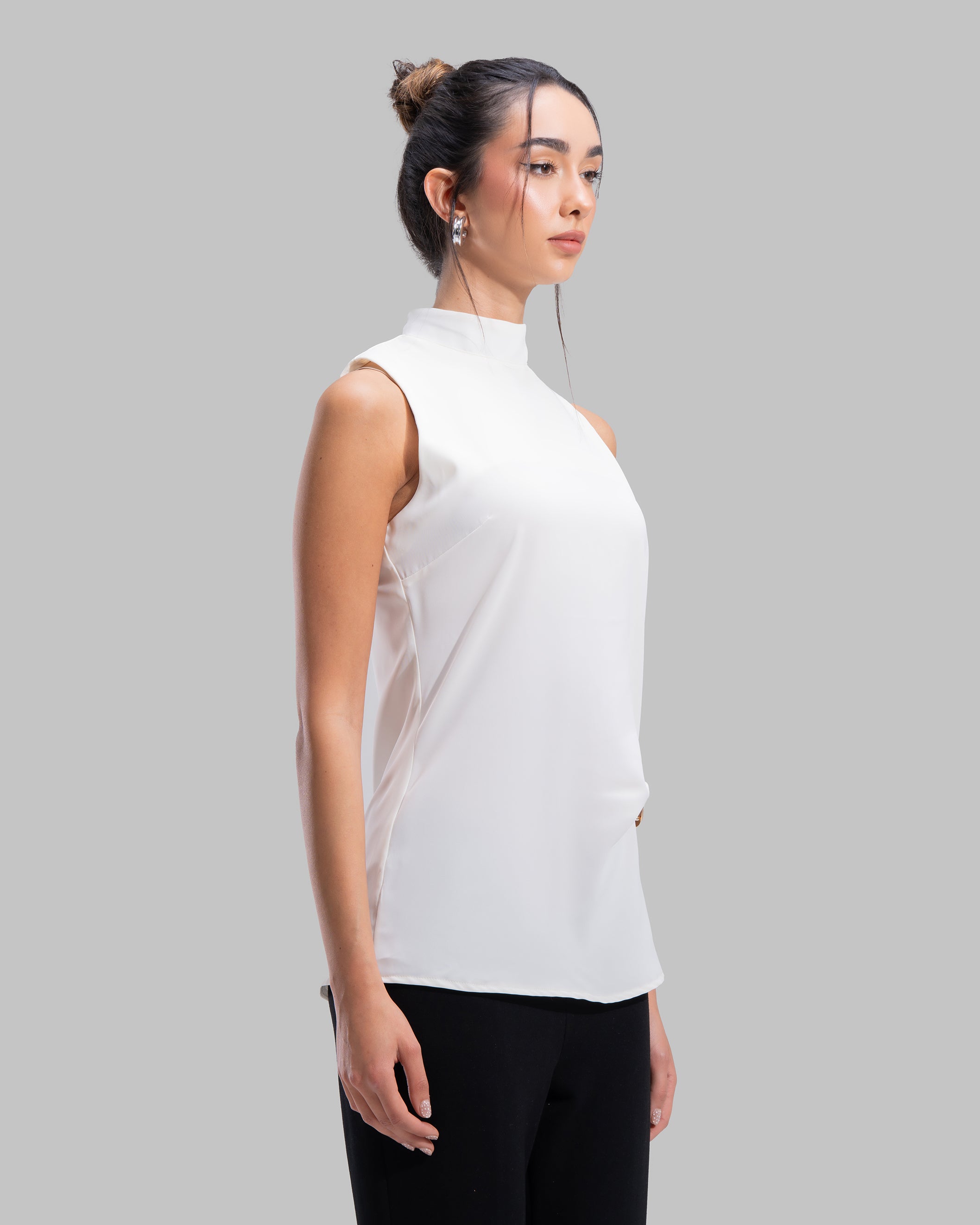 Sleeveless high-neck top with gathered detail and a metallic side buckle.