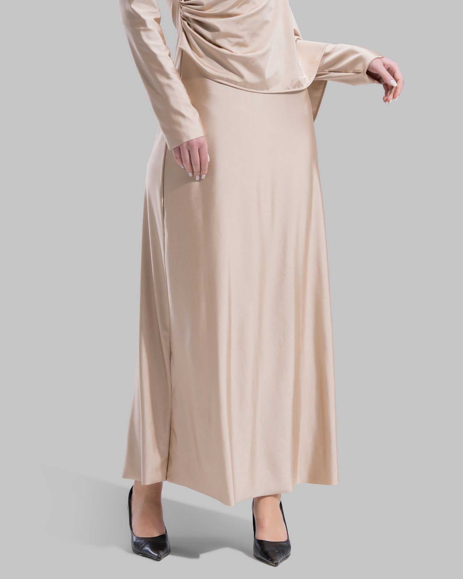 Long draped dress with a round neckline and asymmetrical overlay detail.