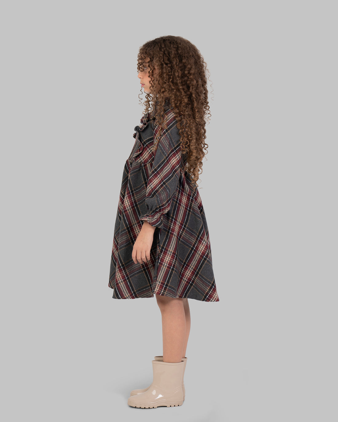 Knee-length plaid dress, with long sleeves.