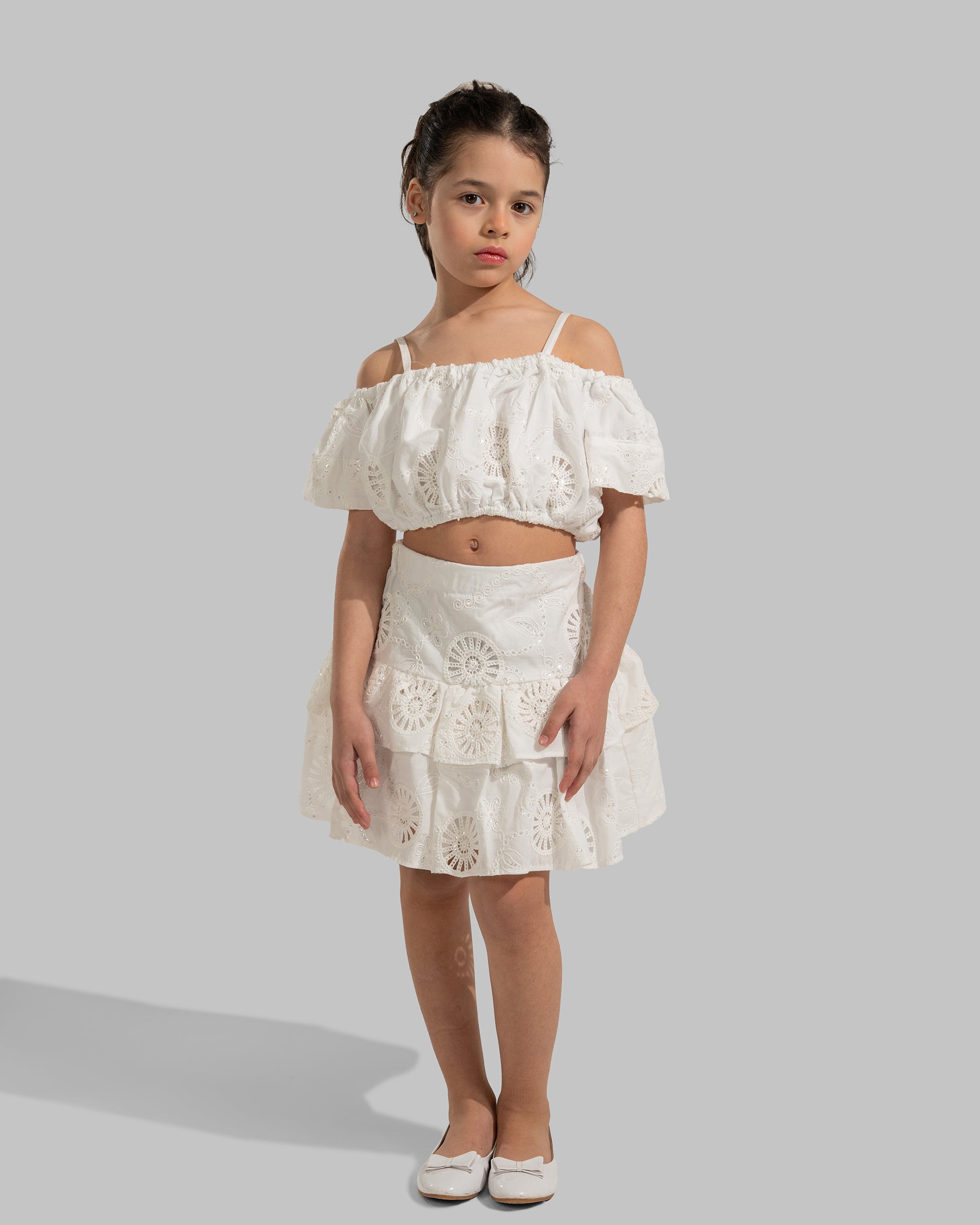 Layered white eyelet mini skirt with a ruffled hem.