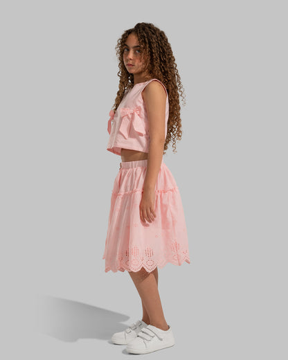 Sleeveless round neck top featuring decorative bows on the sides.