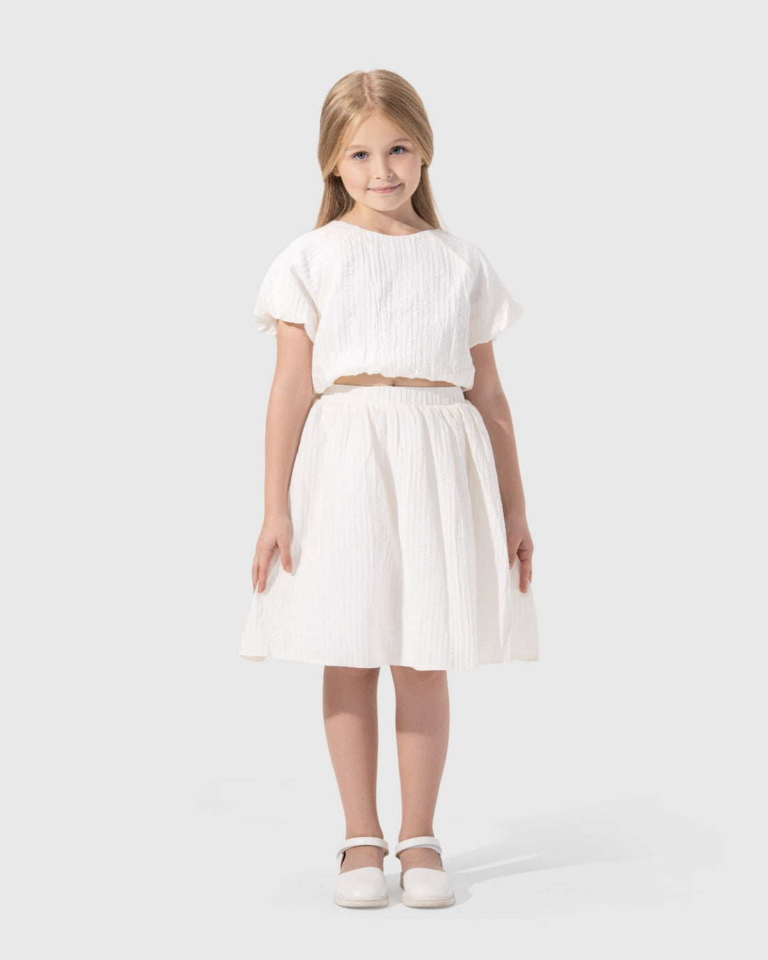 Textured puffy-sleeved top with a round neckline.